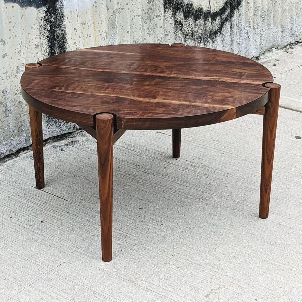August 9th, 2023: This modern walnut coffee table features a unique circular top that appears to float above its supports.